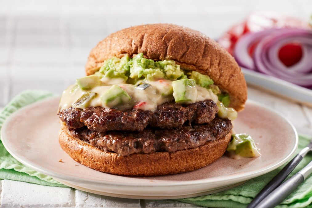 A photo of a Double Smashed Avocado Burger with Hatch Chile Queso