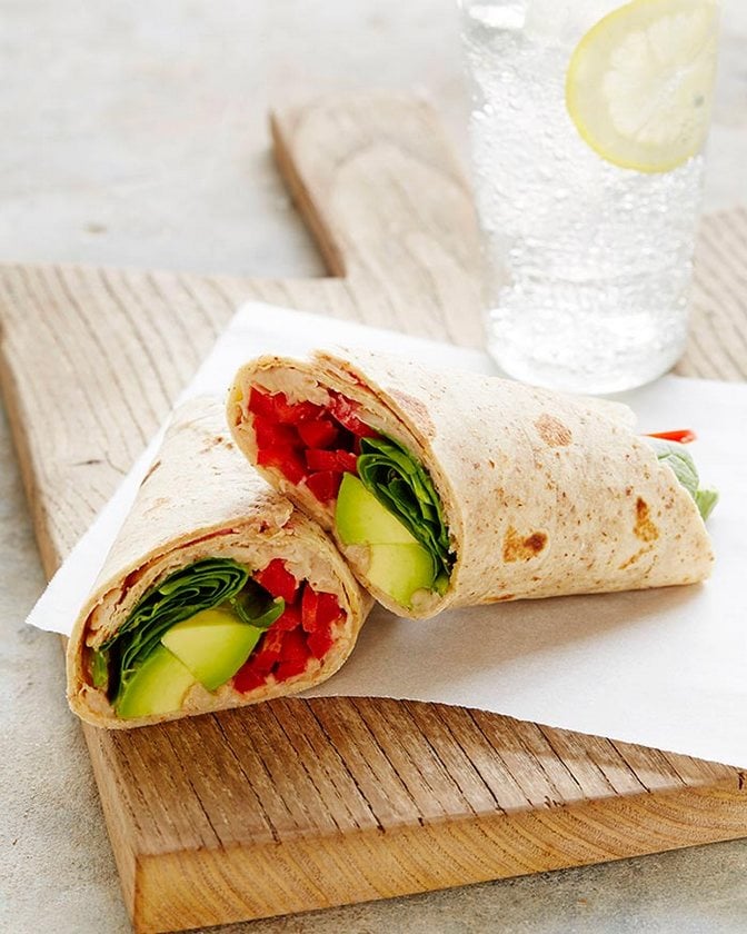 FINAL_CAL_AVO_WHITE_BEAN_SNACK_WRAP_2-embed.jpg White bean avocado snack wrap cut in half