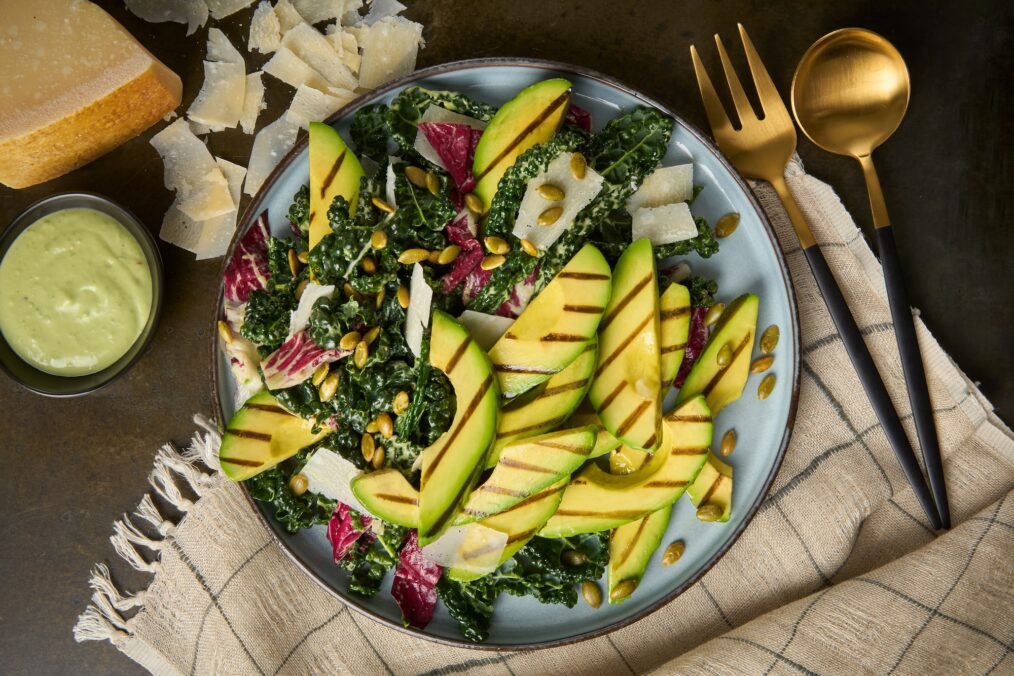 A photo of Grilled California Avocado Kale Caesar Salad