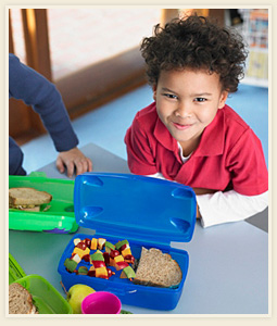 Child and his lunchbox with an avocado fruit salad inside