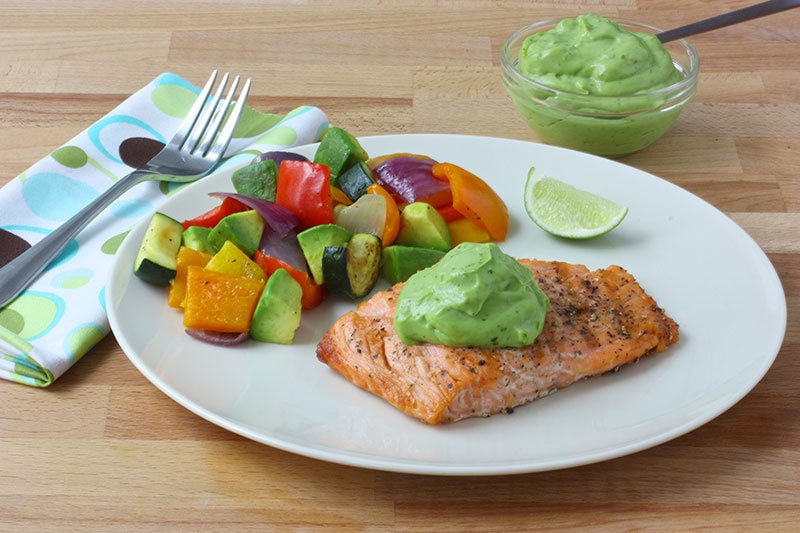 plated-recipe-with-avo-sauce-in-backgrnd-recipe.jpg Plate of grilled veggies and salmon topped off with avocado sauce