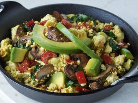 Plate of tofu scramble with avocados and vegetables