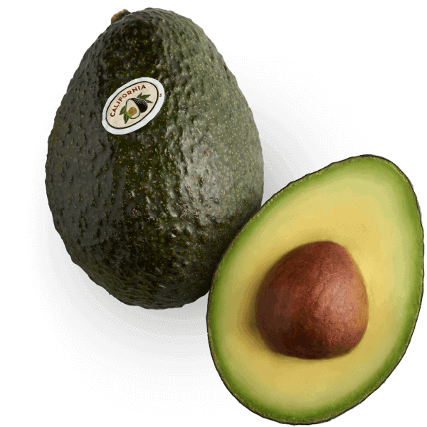 A whole California avocado next to one sliced in half